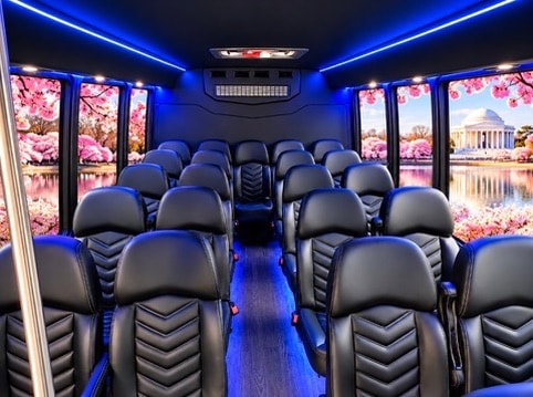 24-passenger bus interior blue ambient lighting black leather chevron seats cherry blossom Jefferson Memorial window views