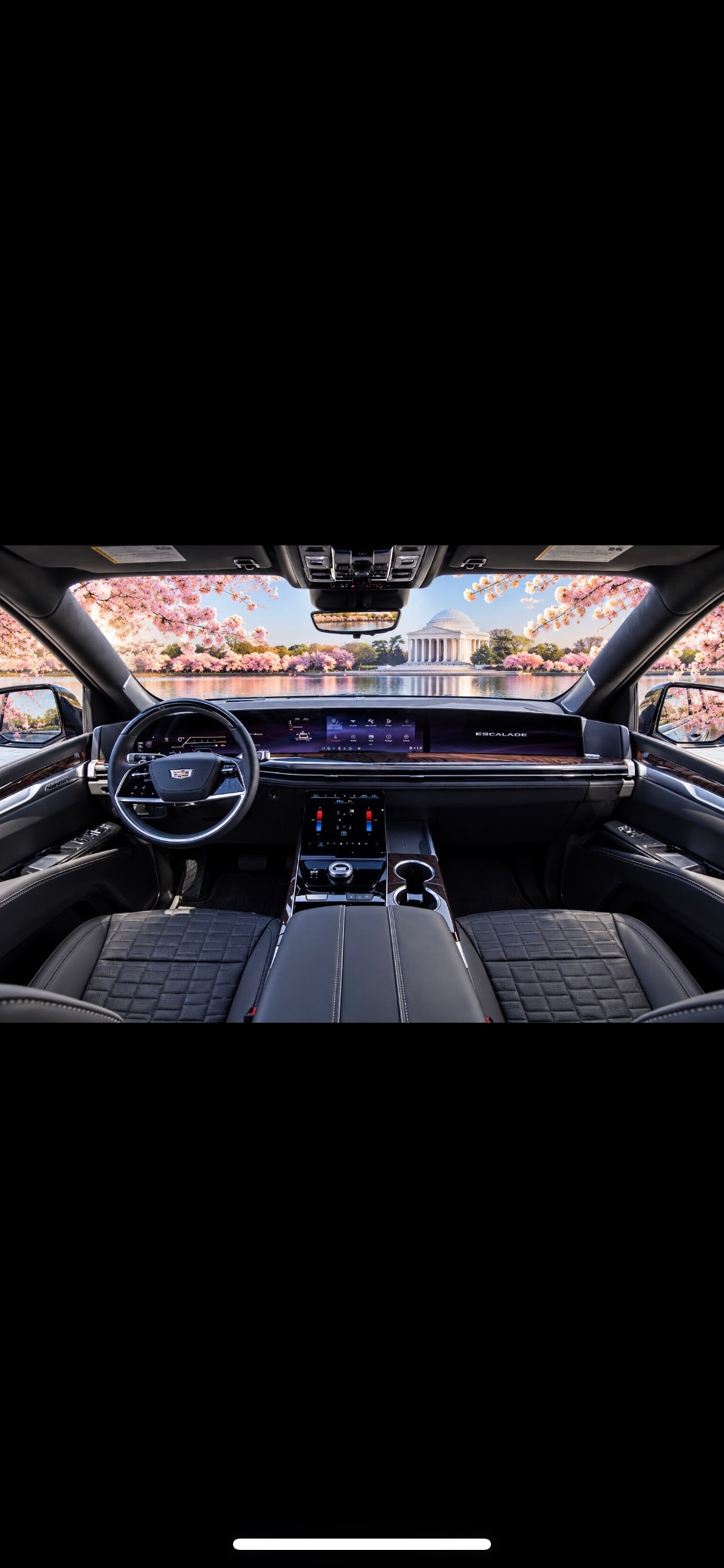 Cadillac Escalade ESV dashboard interior with panoramic Jefferson Memorial cherry blossom view