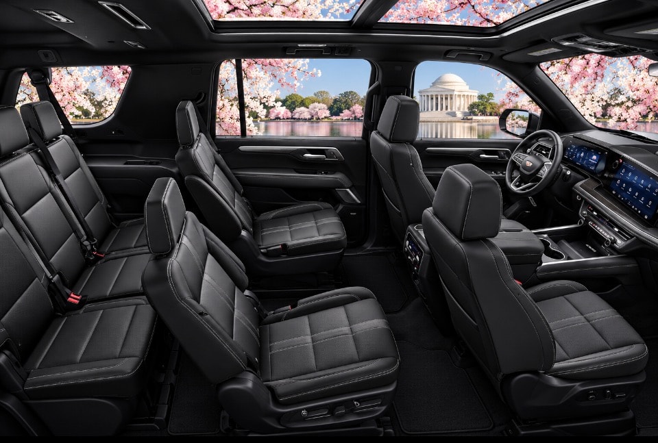 Chevrolet Suburban full three-row black leather interior side view cherry blossoms
