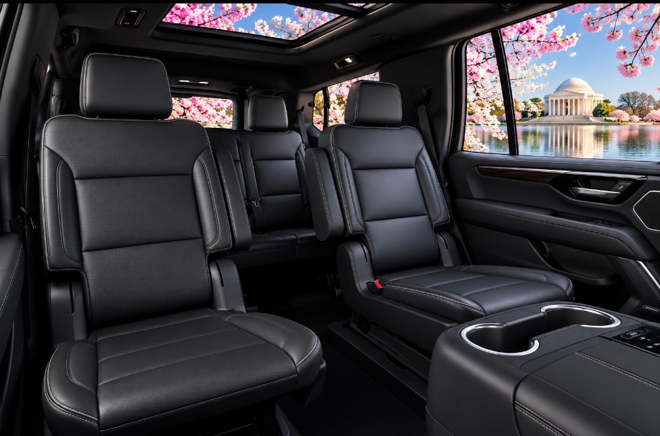 Chevrolet Suburban middle row black leather captain chairs cherry blossoms view