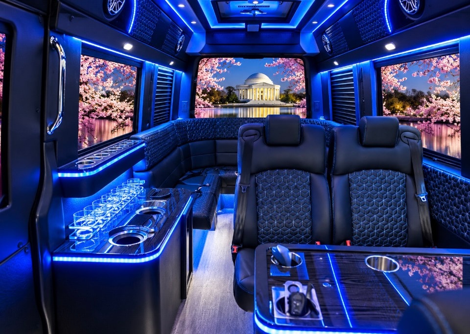 Luxury Sprinter limo interior blue LED bar area with glasses captain seats premium amenities