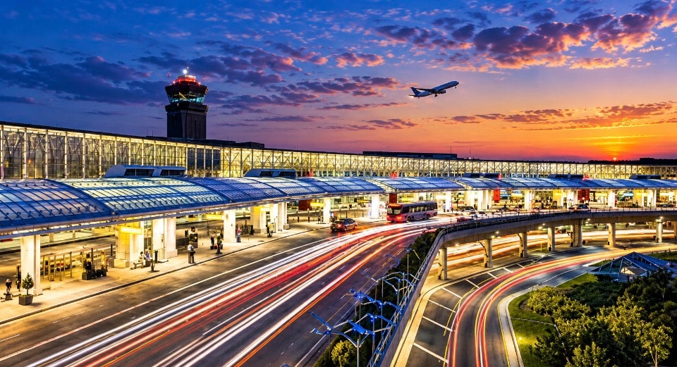 Reagan National Airport at sunset with departing plane