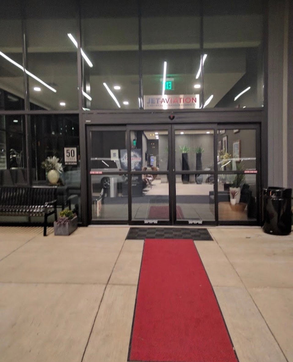 Jet Aviation entrance with red carpet at night