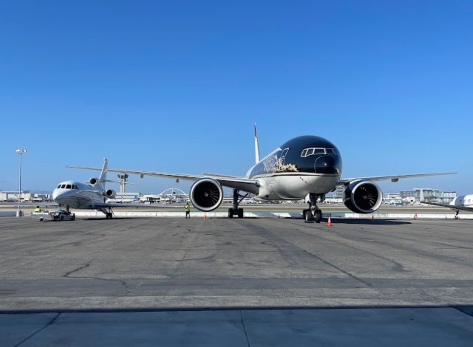 Private jets on airport tarmac clear blue sky
