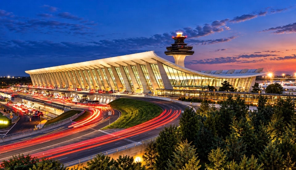 Dulles Airport terminal at night with light trails