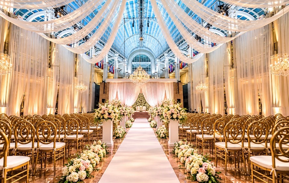 Elegant ballroom wedding ceremony setup with floral aisle