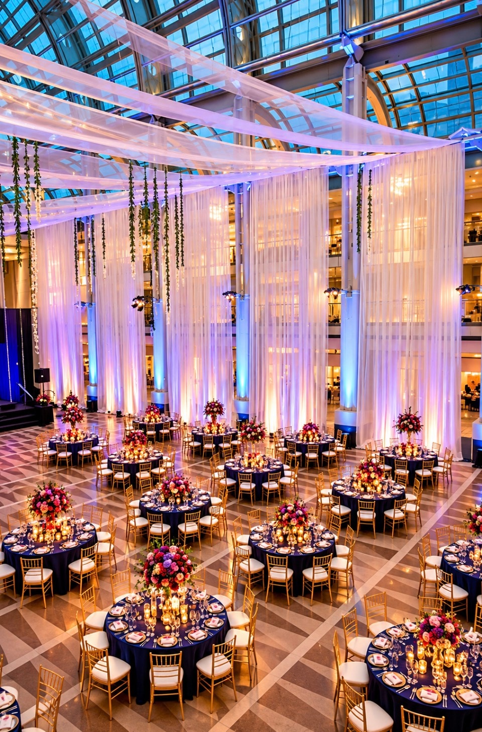Luxury event venue with blue uplighting and round tables