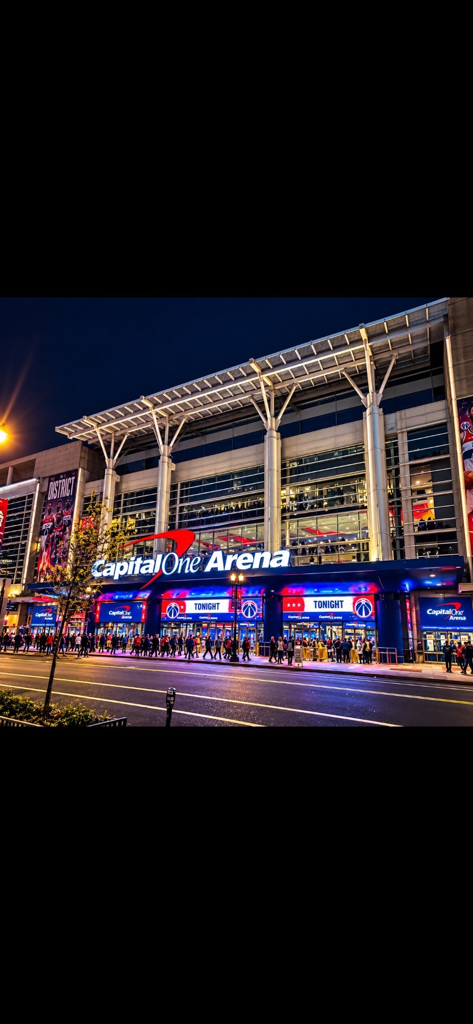 Capital One Arena exterior at night with Wizards game signage