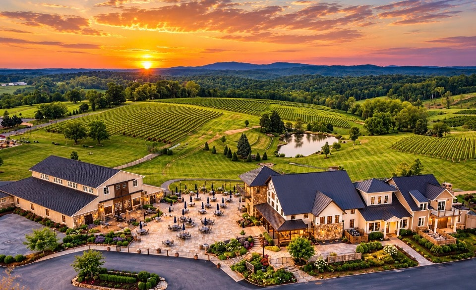 Aerial view of Virginia winery estate at sunset with rolling vineyard hills