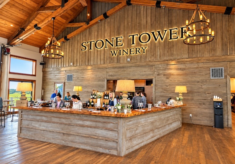 Stone Tower Winery tasting room interior with rustic wood bar