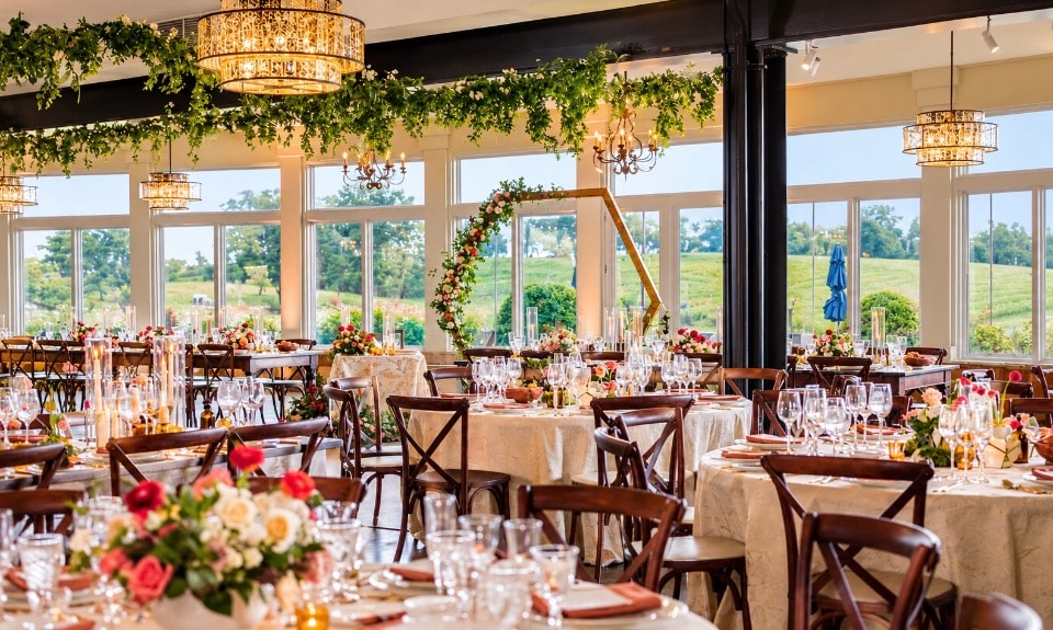 Elegant winery event space with floral arrangements and vineyard views